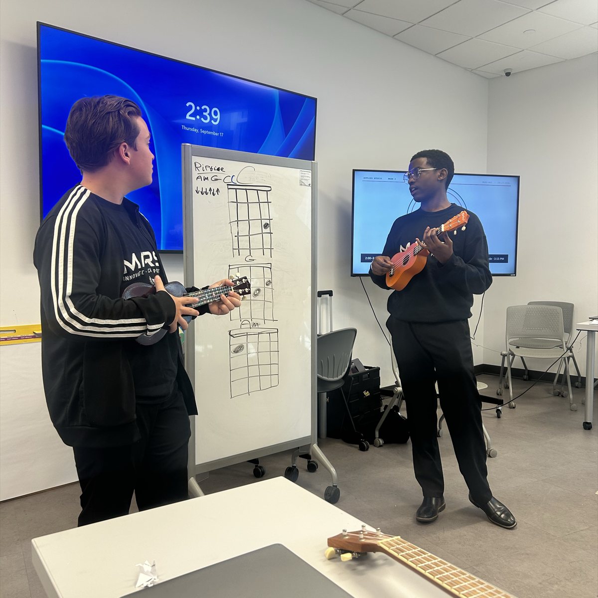 Two MARS students practicing ukulele together.